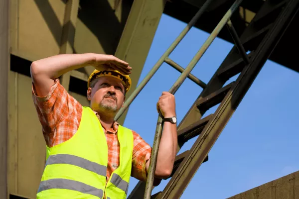 A construction worker safely working at heights. 