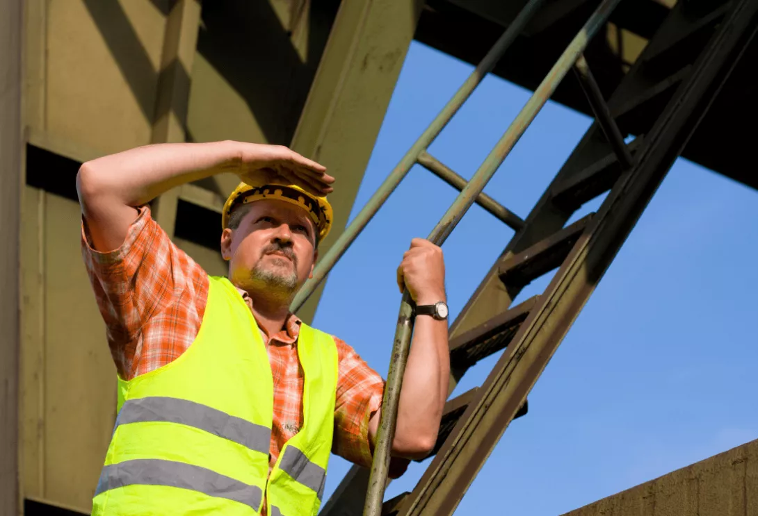 A construction worker safely working at heights. 